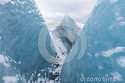 Mountains with clouds on Antarctica. Glaciers, icebergs and ice caves of Southern hemisphere. Global climate change on Earth. Stock Photo