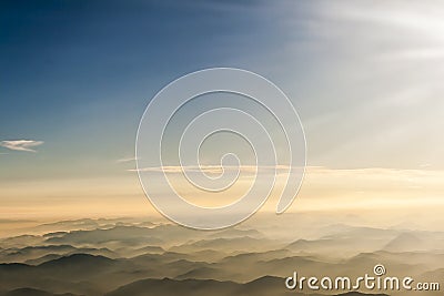 Mountains clouds blue sky and fog photographed from on mountaintop. Stock Photo