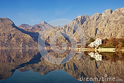 Mountains reflected in the water, winter Mediterranean landscape. Montenegro, Bay of Kotor Stock Photo