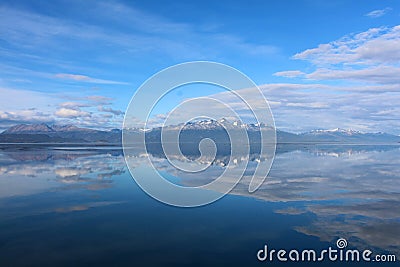 Mountains reflecting in water Stock Photo