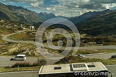 Mountains road in switzerland alps with bus pullma Stock Photo