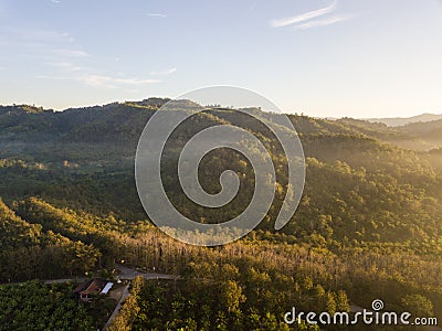 Mountains and trees with beautiful clouds and sky in sunrise Stock Photo