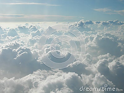 Flying over cotton-like clouds. Mountains of white clouds touching the sky Stock Photo