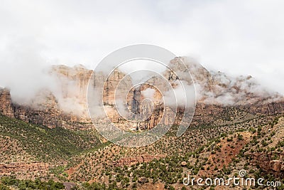 The mountains of Zion National Park in Utah with a heavy overcast and clouds dramatically passing in from of the peaks Stock Photo