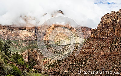 The mountains of Zion National Park in Utah with a heavy overcast and clouds dramatically passing in from of the peaks Stock Photo