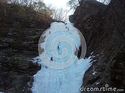 Ice climber climbing frozen water of kangchon waterfall in Chunc Stock Photo