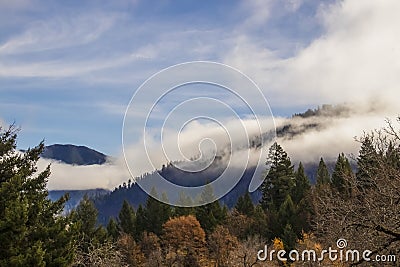 Mountians enveloped with misty fog on an autumn day Stock Photo