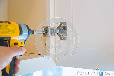 Mounting hinges for chipboard furniture assembling kitchen furniture. Place carpentry workshop Stock Photo