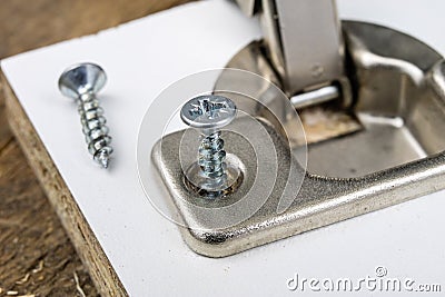 Mounting hinges for chipboard furniture. Joinery accessories use Stock Photo