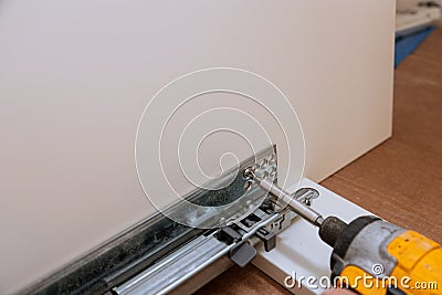 Mounting hinges for furniture accessories used when assembling kitchen furniture Stock Photo