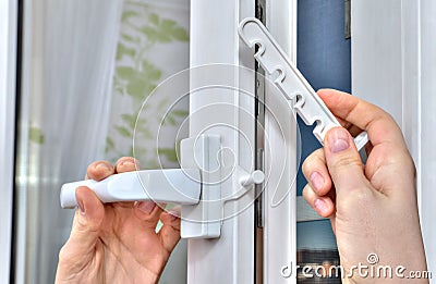Mounting opening restrictor for PVC window, close-up. Stock Photo