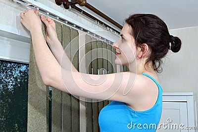 Mounting shutters, Girl hook fabric blinds slats, Install blinds Stock Photo
