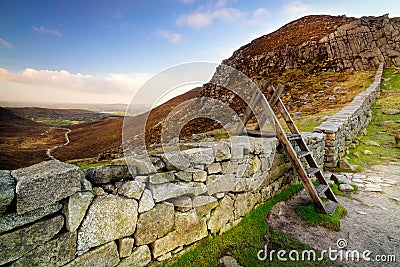 Mourn Wall with ladder on the Hares Gap overseeing beautiful valley with blue sky and white clouds Stock Photo