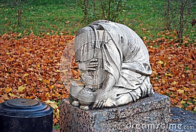 Mournful sculpture on a gravestone. Goritsky Monastery of Dormition in the city of Pereslavl-Zalessky. Russia Stock Photo