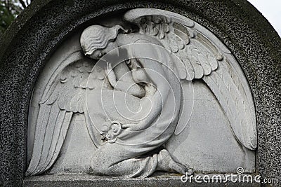 Mourning angel at the abandoned cemetery. Stock Photo