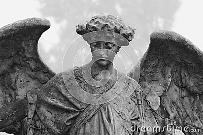 Mourning angel sitting on mausoleum on Cemetery Cimitero Monumentale Milan, Italy Stock Photo