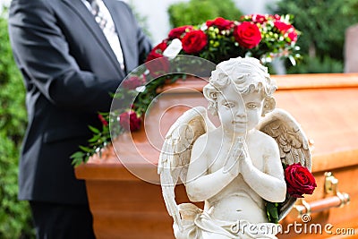 Mourning man at Funeral with coffin Stock Photo