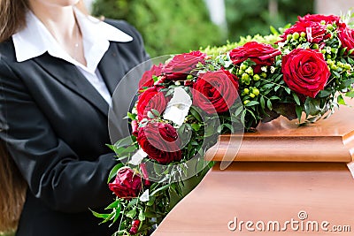 Mourning Woman at Funeral with coffin Stock Photo