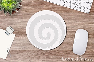 Mouse pad mockup. Round white mat on the table with props, mouse and keyboard Stock Photo