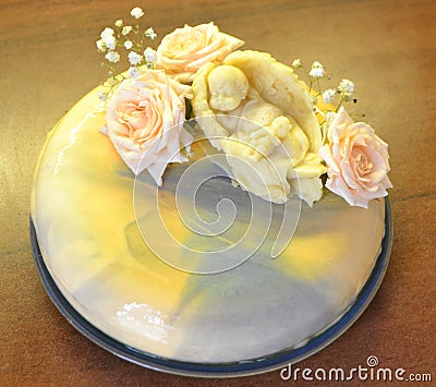 Bright mousse cake with mirror glaze. Decored by chocolate ange and roses in pastel colors Stock Photo