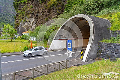 mouth of exit of the road tunnel of são vicente with 2404 meters, light car in motion, Madeira island. Editorial Stock Photo