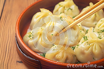 Mouthwatering manti dumplings showcased elegantly against wooden backdrop Stock Photo