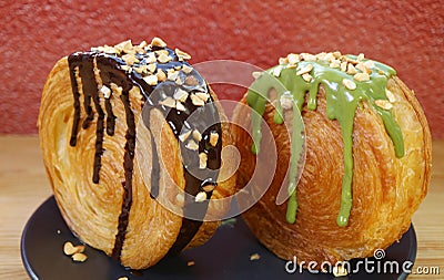 Pair of Circle Shaped Supreme Croissants with Chocolate and Pistachio Ganache Stock Photo