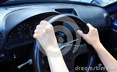 Always on the move. Close-up of female hands on steering wheel Stock Photo