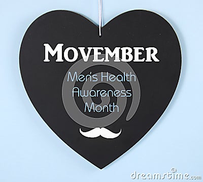 Movember fundraising for mens health awareness message on blackboard Stock Photo