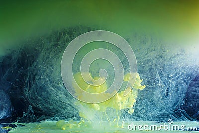 Movement of colored paints - green and yellow Stock Photo