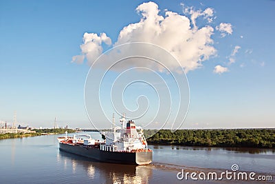 The movement of sea merchant ships and tugs to the entrance and exit from the port. Beaumont, Texas Stock Photo