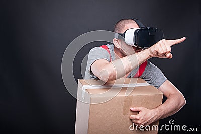 Mover guy holding box pushing button wearing vr glasses Stock Photo