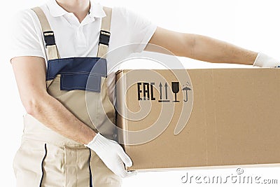 Mover holding in hands cardboard box isolated on white background. Relocation services concept. Loader in uniform with box Stock Photo