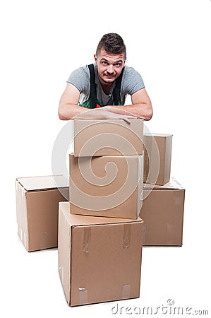 Mover man posing behind cardboard boxes Stock Photo