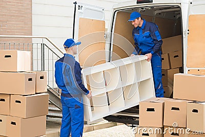 Movers Unloading Furniture From Truck Stock Photo