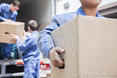 Movers unloading a moving van Stock Photo