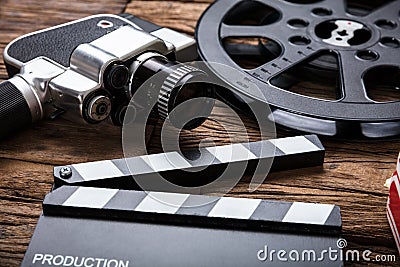 Movie Camera With Film Reel And Clapper Board On Wood Stock Photo