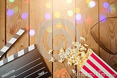 Movie clapper board, 3d glasses and popcorn on wooden background. Cinema concept. Stock Photo