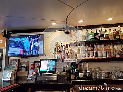 Movie plays on TV inside Local Downbeat Diner Bar Editorial Stock Photo