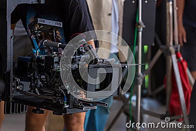 Movie shooting or video production and film crew team with camera equipment. Video camera operator working with equipment. Directo Stock Photo