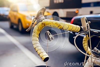 Moving by bicycle in the city. Bike is alternative, ecological and fast city transport. Bicycle wheel against city bus taxi Stock Photo