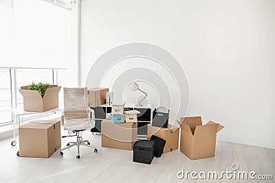 Moving boxes and furniture in office Stock Photo