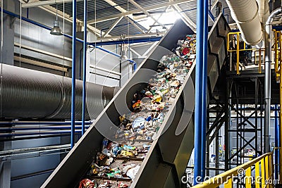 Moving conveyor transporter on Modern waste recycling processing plant. Separate and sorting garbage collection. Recycling and Stock Photo