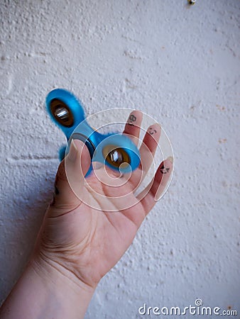 Moving Fidget Spinner in Hand Stock Photo