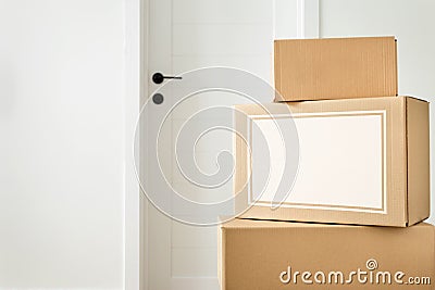 Moving home concept. Stack cardboard boxes in living room Space for text Stock Photo