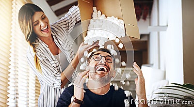 Moving house, property and box with a silly married couple having fun while playing in their new home together. Real Stock Photo