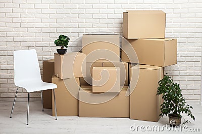 Moving into a new apartment. Move lots of cardboard boxes in an empty new apartment. Stock Photo