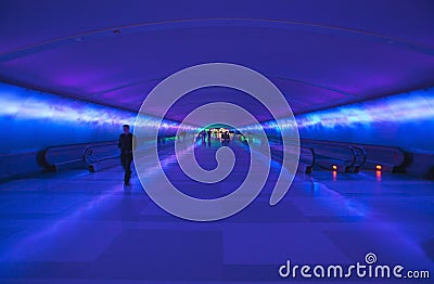 Moving sidewalks and a changing light show in the tunnel of the Detroit Airport, Detroit, Michigan Editorial Stock Photo