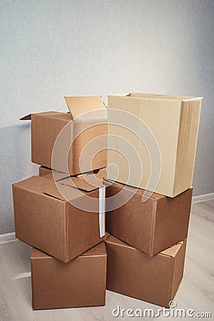 Moving in. Stack of cardboard boxes in the empty room Stock Photo