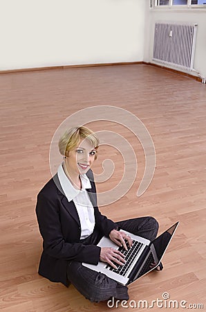 Moving to new office: Businesswoman with laptop Stock Photo